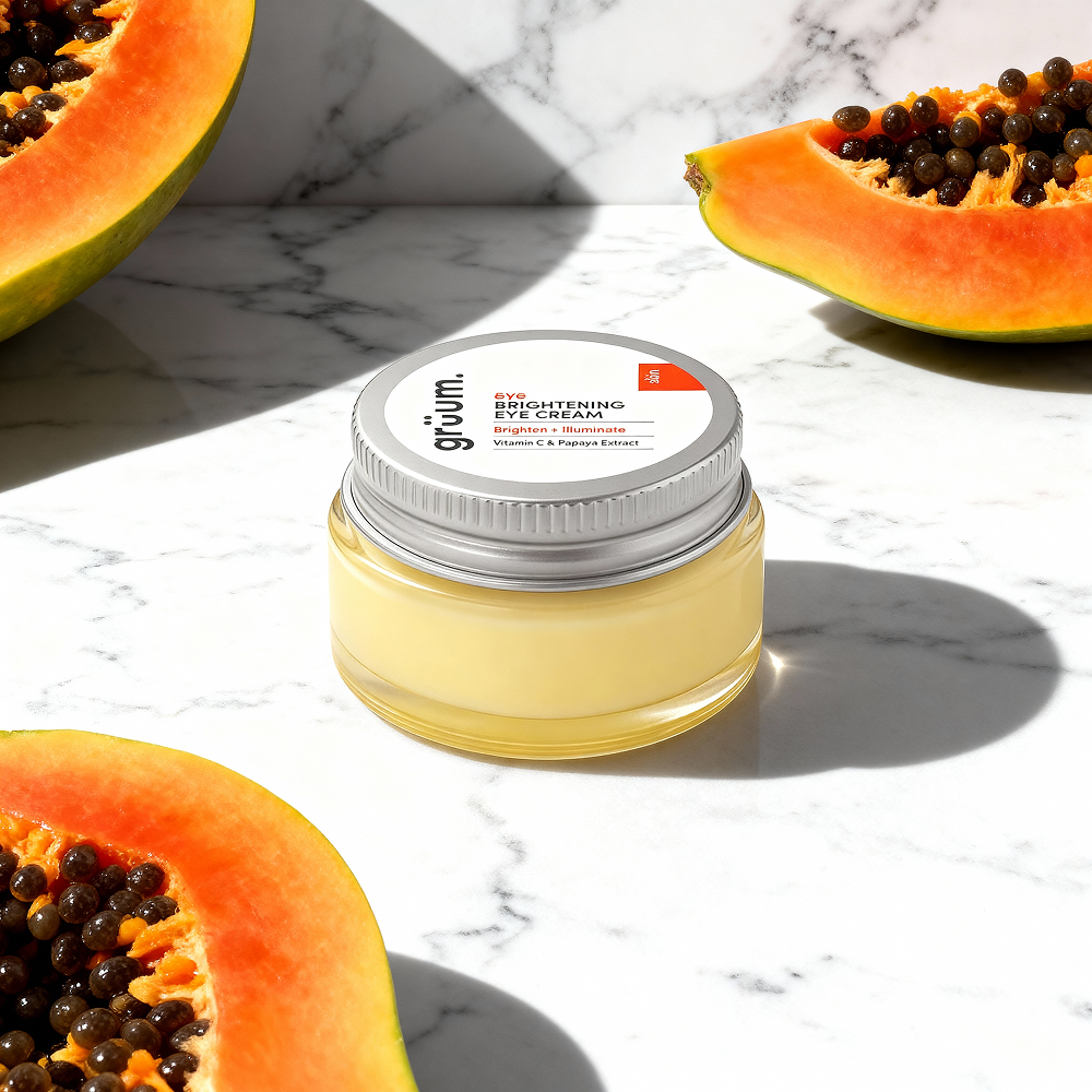Eye cream with papaya on marble surface.