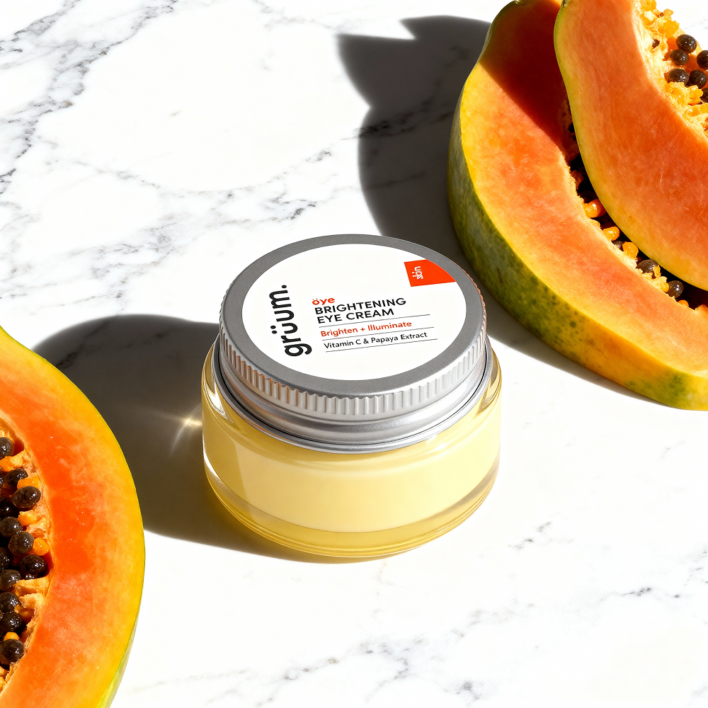 Eye cream jar and papaya slices