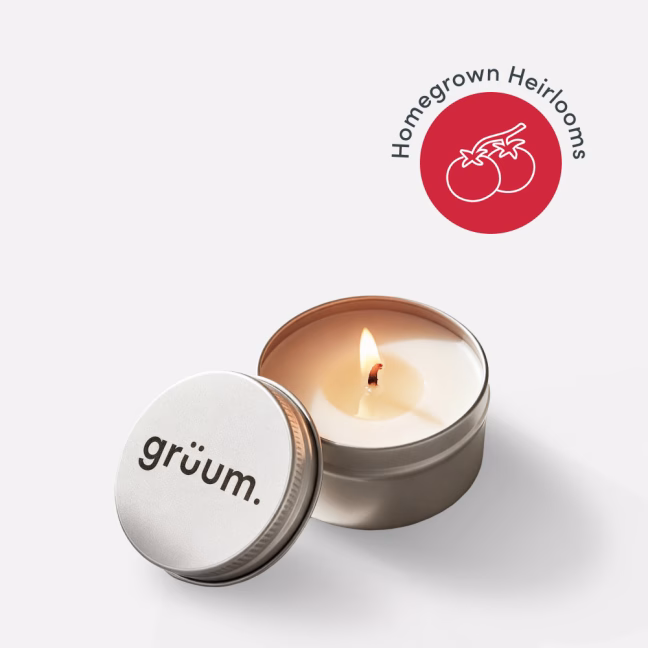 Lit candle and tin with tomatoes logo.