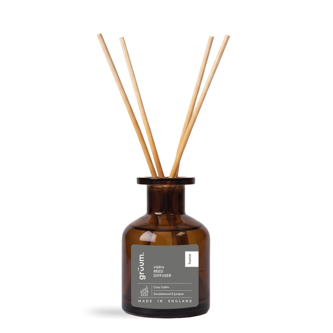 Brown glass reed diffuser with sticks.
